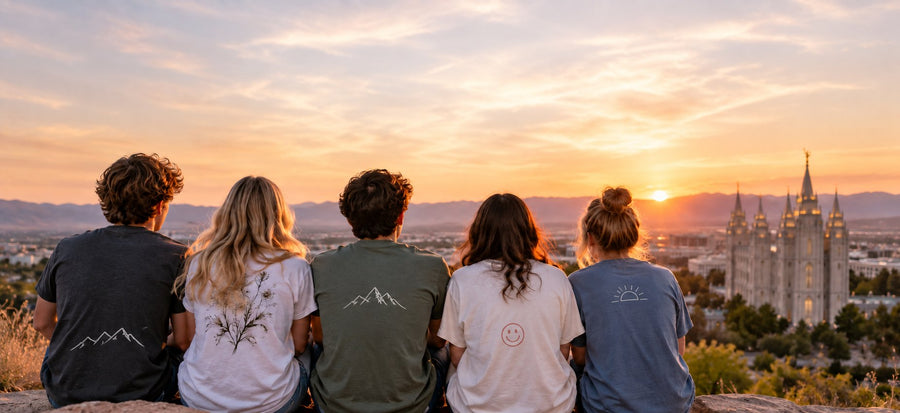 Five youth seen from behind watching a sunset over the valley with a temple in the distance.